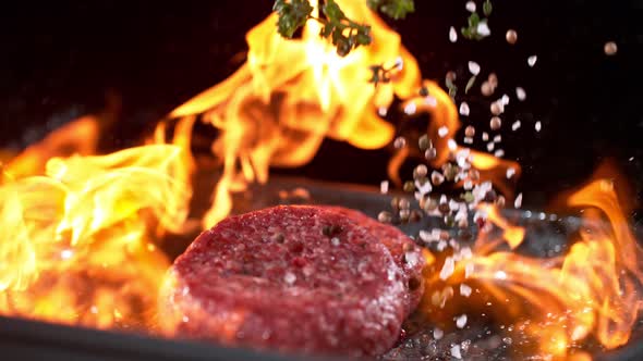 Super Slowmotion Footage of Throwing Fresh Beef Meat Burger on Ignited Pan, 1000Fps 