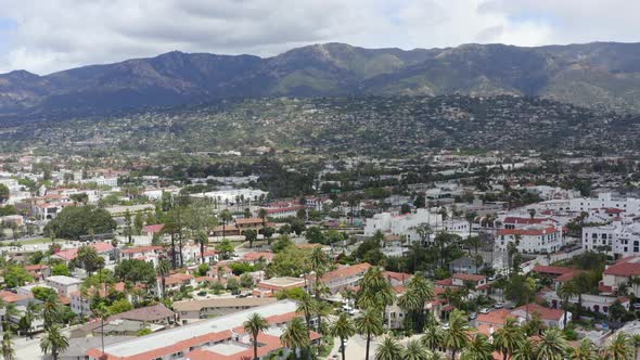 Rising Aerial Pan of Santa Barbara City with Palm Trees and Coastal Mountains