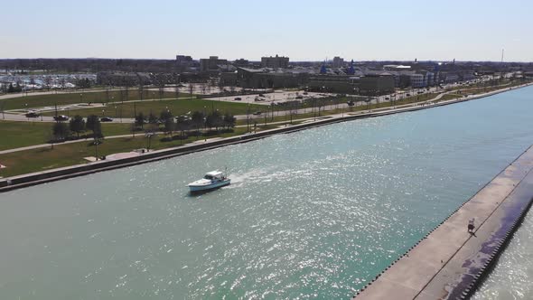 Aerial View Fishing Boat Sails in the River Canal. White Boat Floats on the River in the Open Sea on