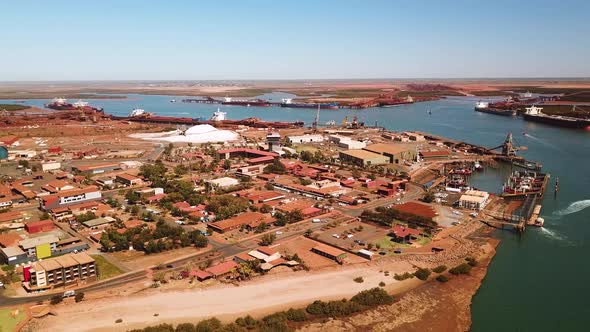 Circling aerial shot of working port town, Port Hedland, Western Australia