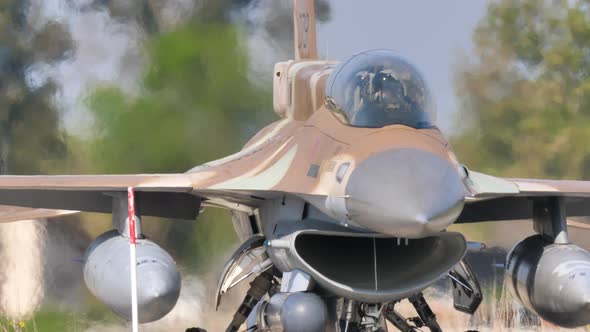 Frontal Close Up View of a Military Combat Aircraft Stopped with Engine Running