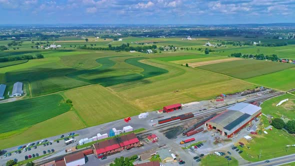 Aerial Traveling View of Corn Fields and Harvesting Crops, with Patches of Color