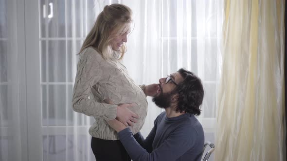 Side View of Blond Caucasian Woman and Her Husband Indoors