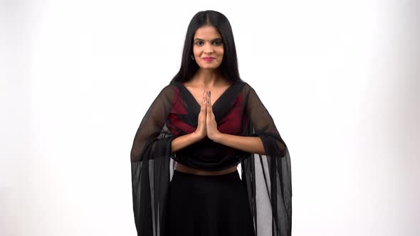 Indian girl saying namaste in Indian attire