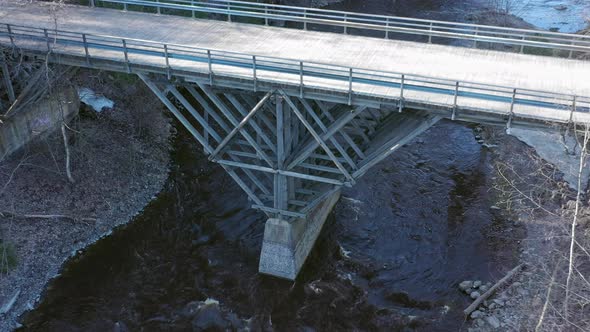 Amazing Drone Point of View of a Wooden Bridge Crossing a River