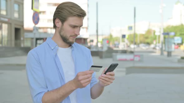 Excited Man Shopping Online Via Smartphone Outdoor