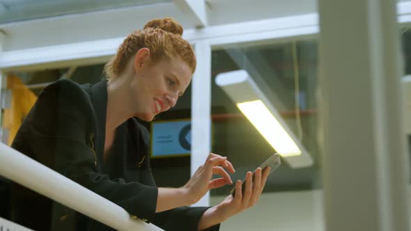 Businesswoman using mobile phone in office 4k