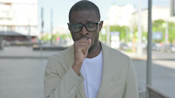 Portrait of African Man Coughing Outdoor