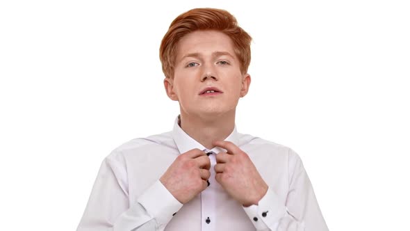 Young Confident Foxy Caucasian Man Straighten Collar and Doing Hair Up in Front of Camera on White