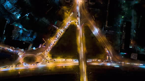 Aerial View of Road Intersection with Fast Moving Heavy Traffic at Night