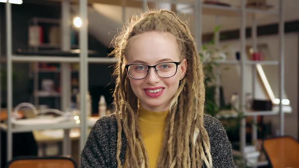 Woman with Dreadlocks Standing in the Middle of Modern Workroom