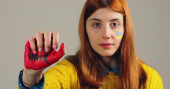 Girl Opens Her Red Hand with Written Stop War Against Conflicts in Ukraine