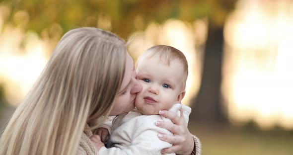 Loving Mother with a Baby in Spring Park