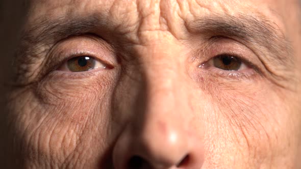 One Eye of the Elderly Man Looks to the Side