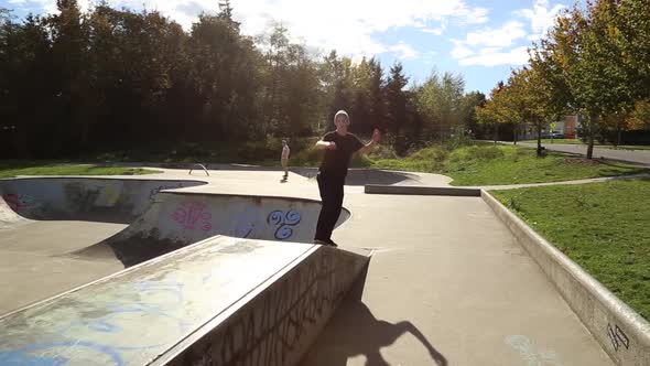 A young skateboarder going off ramps at a skate park.