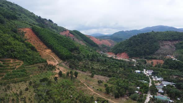 Aerial flying forward over deforestation site for agriculture, Vietnam