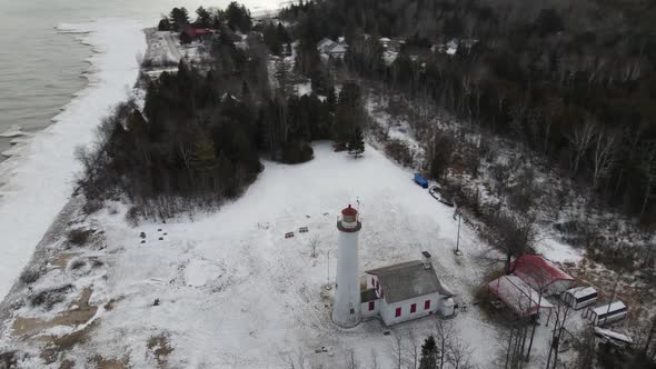 4k drone video of Sturgeon Point Lighthouse in Sturgeon Point Lighthouse in Michigan during the wint