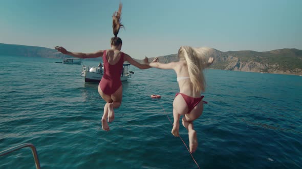 Two Girlfriends Jump From a Yacht Into the Water