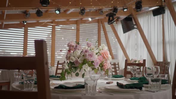 A Dining Table Decorated with Flowers in a Bright and Beautiful Hall