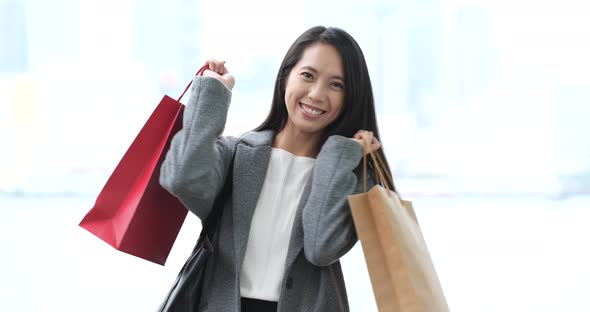 Woman look at mobile phone with shopping bag