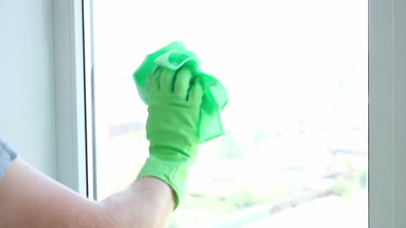 A Man Washes Glass Window and a Plastic Frame with a Folk Remedy with Household Soap