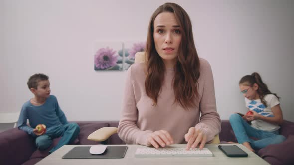 Happy Business Woman Work at Home with Child on Background