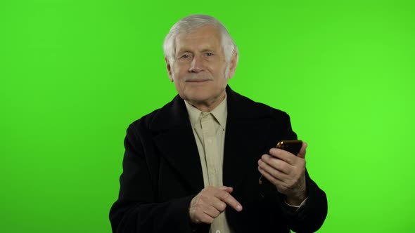 Elderly Stylish Caucasian Grandfather Man Using Social Media App on Smartphone