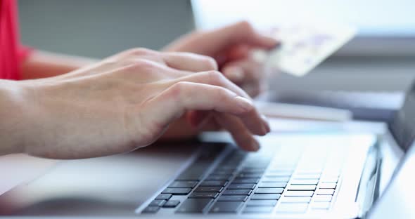 Woman is Typing on Keyboard and Holding Credit Bank Card Slow Motion  Movie