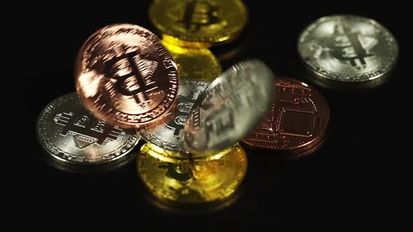 falling of cryptocurrency physical bitcoin on black background, new virtual money