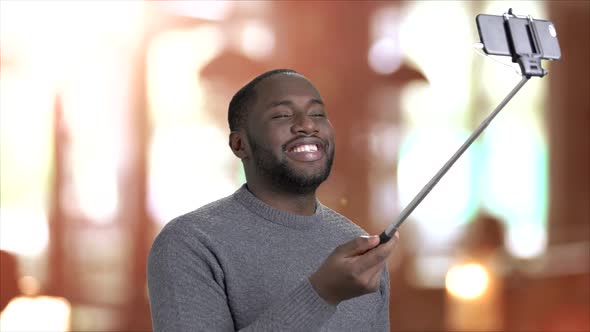 Cheerful Guy Using Selfie Stick.