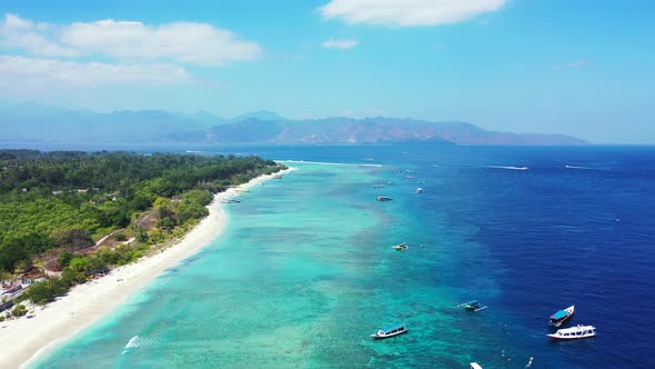 Tropical birds eye clean view of a white sand paradise beach and blue water background in colorful 