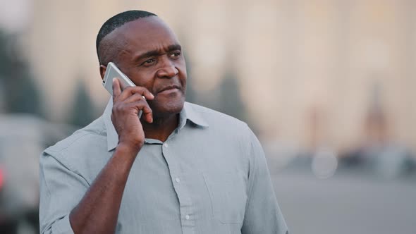 Serious Worried Nervous Mature Adult African American Man Standing Outdoors on Road Background