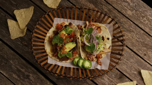 Rotating shot of delicious tacos on a wooden surface - BBQ 