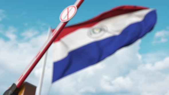 Barrier Gate with STOP CORONAVIRUS Sign Closed at Flag of Paraguay