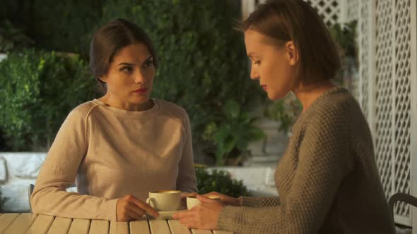 Two Emotional Ladies Having Quarrel, Sitting Outdoors, Misunderstanding Fight