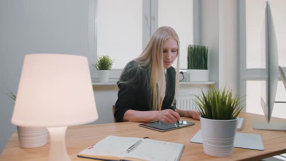 Business Women Working on Tablet in Office