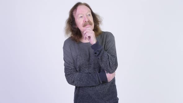 Senior Man with Mustache Thinking Against White Background