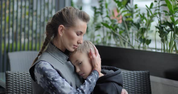 Mom Hugs The Baby. Women Have Bruises Under The Eye. Domestic Violence