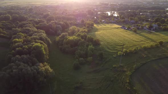 Shine of the morning sun in the lens of a quadcopter camera flying over a field