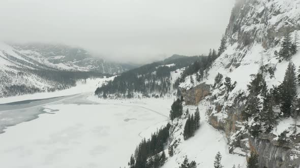 Aerial of snow covered mountain wall overlooking valley