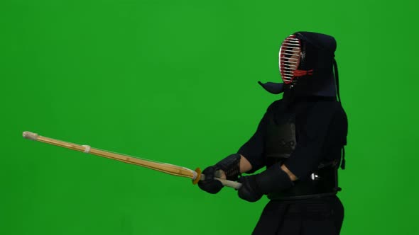 Masculine Kendo Warrior Practicing Martial Art with the Bamboo Bokken on Green Screen. CLose Up