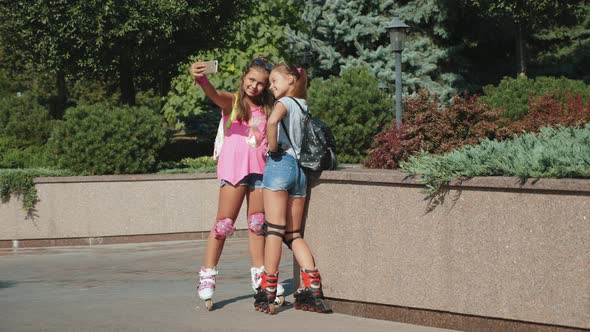 Two Teenage Girls on Roller Skates Make Selfie