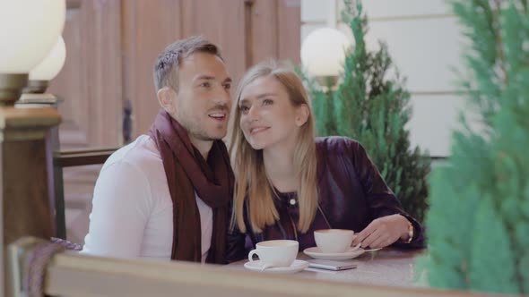 Romantic Couple Drinking Coffee On Date At Street Cafe