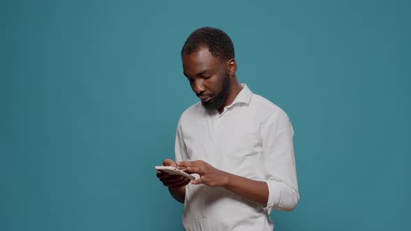 African American Person Working on Modern Smartphone