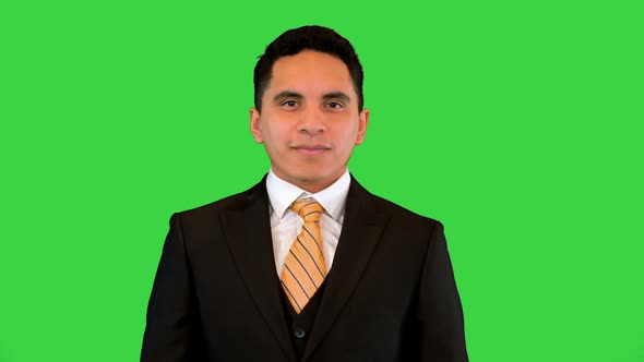 Handsome Happy Young Business Man Giving Thumbs Up Sign on a Green Screen Chroma Key