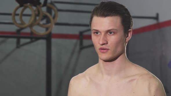 Young Shirtless Man Working Out with a Kettle Bell