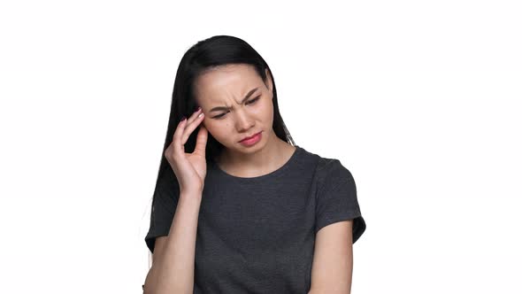 Portrait of Exhausted Asian Woman 20s Feeling Sick Massaging Temples with Fingers and Suffering From