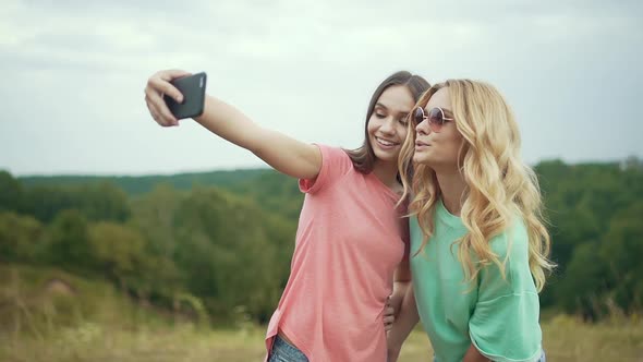 Beautiful Girls Taking Photos On Phone In Nature.