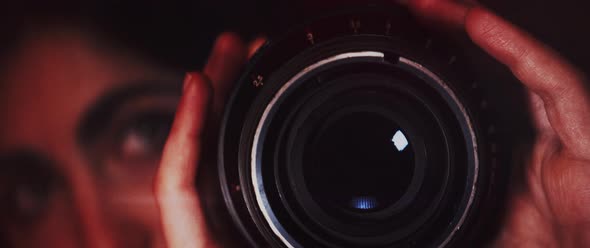 Photographer closing aperture of the lens
