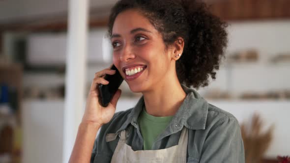 Smiling African woman talking by phone